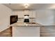 Modern kitchen with a large center island featuring granite countertops and stainless steel appliances at 1797 Old Dogwood, Jonesboro, GA 30238