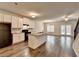 Bright, open-concept kitchen featuring an island, granite counters, white cabinets, and hardwood floors at 1797 Old Dogwood, Jonesboro, GA 30238