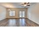 Spacious living area with hardwood floors, ceiling fan, a chandelier and a window at 1797 Old Dogwood, Jonesboro, GA 30238