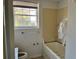 Bathroom featuring a tub, window and toilet at 1920 Anastasia Ln, Atlanta, GA 30341