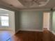 Spacious bedroom with hardwood floors, tray ceiling, and natural light from a window at 1920 Anastasia Ln, Atlanta, GA 30341