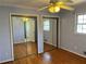 Bedroom with hardwood floors, mirrored closet doors, and natural light at 1920 Anastasia Ln, Atlanta, GA 30341