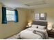 Simple bedroom with a plush bed, window with curtains, and neutral-colored walls at 1920 Anastasia Ln, Atlanta, GA 30341