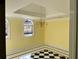 A bright dining room with a tray ceiling, chandelier, and black and white tile flooring at 1920 Anastasia Ln, Atlanta, GA 30341