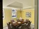 Bright dining room features a classic chandelier and a large window for natural light at 1920 Anastasia Ln, Atlanta, GA 30341