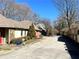 View of the home showcasing its stone and stucco exterior, and a side-entry garage at 1920 Anastasia Ln, Atlanta, GA 30341