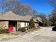 View of the home showcasing its stone and stucco exterior, and a side-entry garage at 1920 Anastasia Ln, Atlanta, GA 30341