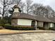 Unique home exterior with stone accents, complemented by well-manicured landscaping at 1920 Anastasia Ln, Atlanta, GA 30341