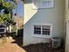 This home's exterior features classic windows, a modern AC unit, and a neatly maintained yard at 1920 Anastasia Ln, Atlanta, GA 30341