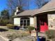 Charming home featuring a stone facade, red door, and manicured landscaping at 1920 Anastasia Ln, Atlanta, GA 30341