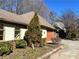 Partial view of a stucco home with a manicured lawn and a view of the attached garage at 1920 Anastasia Ln, Atlanta, GA 30341