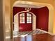 Elegant foyer featuring a red door, marble floors, and classic architectural details at 1920 Anastasia Ln, Atlanta, GA 30341