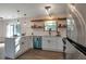 Modern kitchen with stainless steel appliances, white cabinets, quartz countertops, and decorative wood shelves at 1974 Young Rd, Lithonia, GA 30058