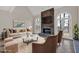 Staged living room with stone fireplace, tile floors, high ceilings, and double French doors at 3229 Cobbs Farm Nw Trl, Marietta, GA 30064