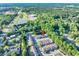 Aerial view of townhomes and Meridian Park nearby surrounded by lush greenery at 233 Tara Commons Walk, Loganville, GA 30052