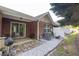 Cozy brick patio with outdoor seating and grill, surrounded by a well-maintained yard at 233 Tara Commons Walk, Loganville, GA 30052