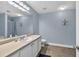 Well-lit bathroom with vanity, expansive mirror, neutral countertop, and a shower/bathtub combination at 233 Tara Commons Walk, Loganville, GA 30052