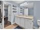 Bathroom featuring a large mirror, white vanity and neutral countertops, along with an ensuite at 233 Tara Commons Walk, Loganville, GA 30052