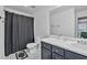 Clean bathroom featuring a sleek vanity, a large mirror, and a shower with a black curtain at 233 Tara Commons Walk, Loganville, GA 30052