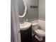 Compact bathroom featuring a vanity with a sink, a toilet, and decorative accents at 233 Tara Commons Walk, Loganville, GA 30052