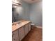 Bathroom with a white vanity, sink, and blue walls, creating a clean and simple aesthetic at 233 Tara Commons Walk, Loganville, GA 30052