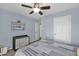 Cozy bedroom with ceiling fan, neutral walls, and a dresser for ample storage at 233 Tara Commons Walk, Loganville, GA 30052