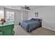 Bright bedroom featuring grey carpet, ceiling fan, and natural light at 233 Tara Commons Walk, Loganville, GA 30052