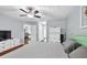 Comfortable bedroom featuring a ceiling fan, ensuite and dresser with light blue walls at 233 Tara Commons Walk, Loganville, GA 30052