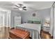 Charming bedroom with light green headboard, ceiling fan, hardwood floors, and abundant natural light at 233 Tara Commons Walk, Loganville, GA 30052