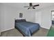 Neutral bedroom with grey carpet, ceiling fan, and ensuite bathroom access at 233 Tara Commons Walk, Loganville, GA 30052