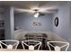 Cozy dining area with a dark wood table and white chairs beneath a ceiling fan at 233 Tara Commons Walk, Loganville, GA 30052