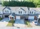 Aerial view of a townhouse with a front-facing garage, and tidy landscaping at 233 Tara Commons Walk, Loganville, GA 30052