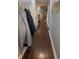 Entryway hallway with hardwood floors, coat hooks, and doors leading to various rooms at 233 Tara Commons Walk, Loganville, GA 30052