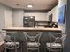 Bright kitchen with white cabinets, stainless steel appliances, and bar seating area at 233 Tara Commons Walk, Loganville, GA 30052