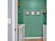 Convenient laundry room in turquoise featuring a white washer, dryer and shelving at 233 Tara Commons Walk, Loganville, GA 30052