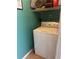 Cozy laundry room with a white washing machine and storage shelf at 233 Tara Commons Walk, Loganville, GA 30052