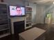 Living room features a fireplace with a flat screen TV and shelving at 233 Tara Commons Walk, Loganville, GA 30052