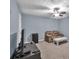 Cozy living room with a ceiling fan, TV, and comfortable seating on neutral carpet at 233 Tara Commons Walk, Loganville, GA 30052