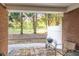 Covered brick patio with grill and seating, perfect for outdoor relaxation and dining at 233 Tara Commons Walk, Loganville, GA 30052