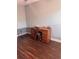 This room features hardwood flooring, a wooden desk, and a wire dog kennel at 233 Tara Commons Walk, Loganville, GA 30052