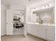 This view into the bathroom shows the double sinks, white cabinets and view into the main bedroom at 1342 Magnolia Way Bnd # 287, Jonesboro, GA 30238