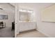 This bathroom features double sinks, white cabinets, a large mirror and decorative artwork at 1342 Magnolia Way Bnd # 287, Jonesboro, GA 30238