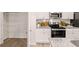 Well-lit kitchen with pantry, stainless steel appliances, and granite countertops at 1342 Magnolia Way Bnd # 287, Jonesboro, GA 30238