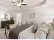 This spacious main bedroom features a tray ceiling with fan, neutral color palette and sitting area at 1342 Magnolia Way Bnd # 287, Jonesboro, GA 30238
