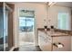 Bright bathroom featuring granite countertops and an adjacent balcony with a stunning city view at 3324 Peachtree Ne Rd # 2118, Atlanta, GA 30326