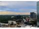 Cityscape featuring corporate buildings surrounded by fog and lush foliage under a cloudy sky at 3324 Peachtree Ne Rd # 2118, Atlanta, GA 30326