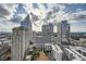 Daytime view of the city skyline with large, modern buildings under a partly cloudy sky at 3324 Peachtree Ne Rd # 2118, Atlanta, GA 30326