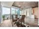Cozy dining area with a glass table, wicker chairs, and expansive windows overlooking the city at 3324 Peachtree Ne Rd # 2118, Atlanta, GA 30326