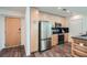 Well-lit kitchen features stainless steel appliances, wood cabinets, and black countertops at 3324 Peachtree Ne Rd # 2118, Atlanta, GA 30326