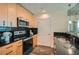Kitchen features wood cabinets, black countertops, and stainless steel microwave at 3324 Peachtree Ne Rd # 2118, Atlanta, GA 30326